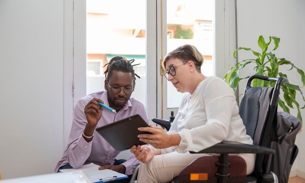 women in wheelchair working with support worker on Plan Management